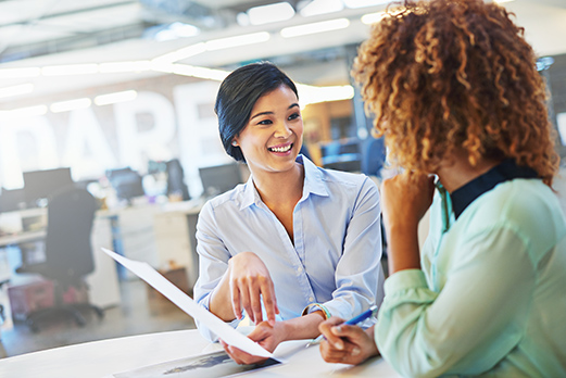 women-discussing-document women discussing a document