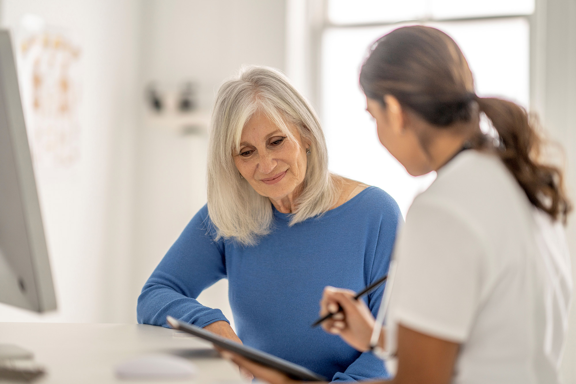 Doctor explaining to elderly patient